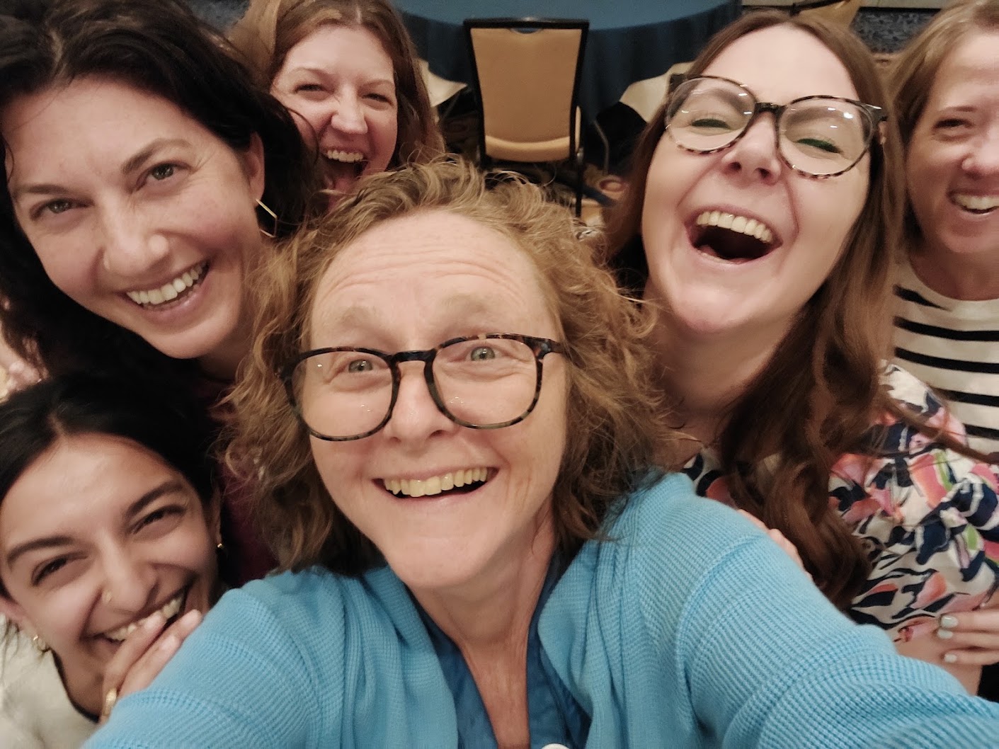 A joyful group selfie of Caja partners and collaborators